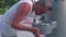 Man drinking water from public drinking fountain on walking street, Miami Beach, Florida, USA. .