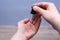 Man dripping oil beard into his palm from a pipette