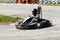 Man drive go kart on track back view