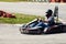 Man drive go kart on track back view