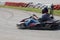 Man drive go kart on track back view