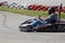 Man drive go kart on track back view