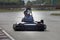 Man drive go kart on track back view