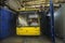 Man driver sitting in the trolleybus cabin while it washing at the auto wash brushes working