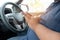 Man driver using mobile phone when driving car on road. people hand holding smart phone driving car, dangerous accident concept