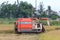 A man drives a combine harvester that harvests rice during the first rice harvest of 2021 in Hoi An, Vietnam