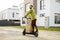 Man drives electric scooter with cardboard packages