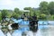 Man drives a lake vegetation harvester