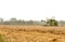 Man Drives Plowing Harvesting Machine On A Big Field Of Wheat Crop, Combine Harvester, Modern Indian Farming Technology,