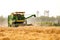 Man Drives Plowing Harvesting Machine On A Big Field Of Wheat Crop, Combine Harvester, Modern Indian Farming Technology,