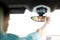 Man driving car adjusting rearview mirror