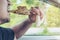 Man driving car while eating grilled pork stick