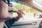 Man driving car while eating grilled pork stick