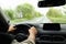 Man driving car on rainy day, closeup