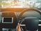 Man driving car from rear view on the highway. Driver`s hands on the steering wheel inside of a car