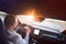 Man driving a car. Success in motion. Handsome young man driving a car. A man holds the steering wheel of a car