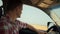 Man driving countryside inside vehicle closeup. Driver inspecting wheat field