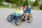Man driving family in pedal car