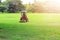 A man driving a lawn mower  On a large football field, in the morning time, outdoors, gardening ideas