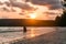 Man driving motobike at sunset on a tropical island