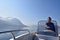 A man driving a motorboat on Lake Lucerne in Switzerland.