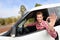 Man driving rental car showing car keys happy