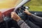 Man driving right hand car. Close-up shot of man`s hands holding steering wheel.