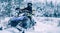 Man driving snowmobile in snowy forest. Man on snowmobile in winter mountain. Snowmobile driving