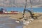 A man driving a Volvo excavator working next to the port at summer in Longyearbyen, Svalbard