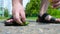 A man drops ice cream on the road, and then removes trash