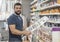 Man in drugstore selecting paint color for his work