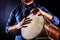 Man is drumming on wooden ethnic drum