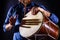 Man is drumming on wooden ethnic drum