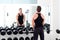 Man with dumbbell weight training equipment gym