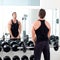 Man with dumbbell weight training equipment gym