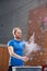 Man dusting powder by climbing wall in crossfit gym