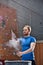 Man dusting powder by climbing wall in crossfit gym