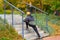 Man with dyed hair in blonde doing stretching on the sports ground outdoors. Open air training