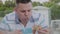 A man eagerly eats junk food in a restaurant.