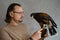 Man with eagle at home. Bird pet in hands