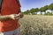 A man with an ear of wheat standing in the field