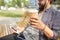 Man with earphones and smartphone drinking coffee