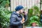 Man eating a croissant and drinking coffee in a garden