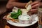 Man eating delicious quesadilla in restaurant