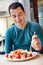 Man eating large portion of salad