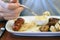 Man eating sausage, sauerkraut, and French mustard