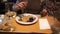 Man eating spaghetti with seafood in a restaurant