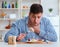 Man eating tasteless food at home for lunch