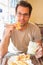 Man eating traditional moroccan breakfast in coffee shop.