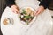 Man eats an appetizing salad with meat with a fork and a knife in his hands